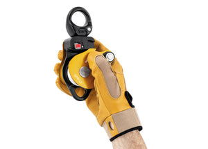 gloved hand holding yellow Petzl Spin L2 double pulley with swivel with open gate Width="1200" Height="861"