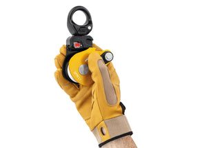 gloved hand holding yellow Petzl Spin L1 pulley with swivel with open gate Width="1200" Height="861"
