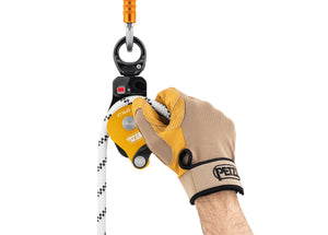 gloved hand placing rope through Petzl Spin L2 double pulley with swivel Width="1200" Height="861"